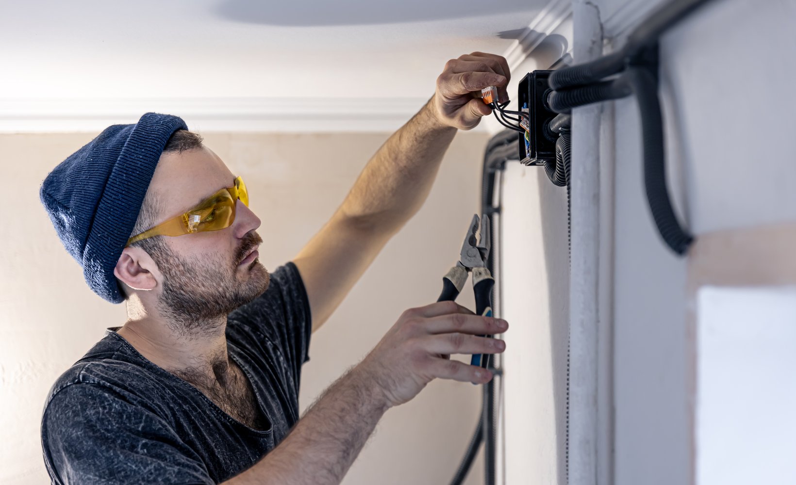 electrician-is-mounting-electric-sockets-white-wall-indoors